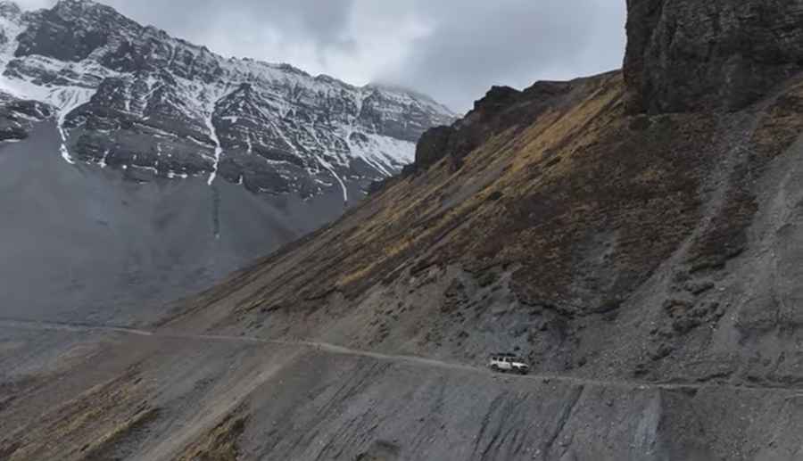 4x4 vehicle driving on the new high-altitude road under construction between Jomsom and Rara Lake, Upper Mustang, Nepal
